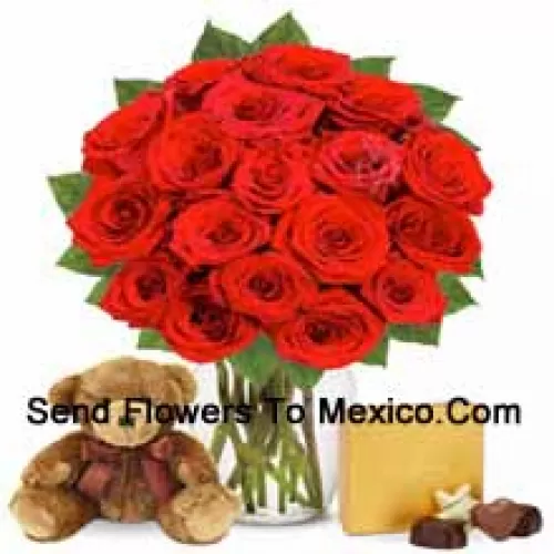 12 Red Roses With Some Ferns In A Glass Vase Accompanied With An Imported Box Of Chocolates And A Cute 12 Inches Tall Brown Teddy Bear