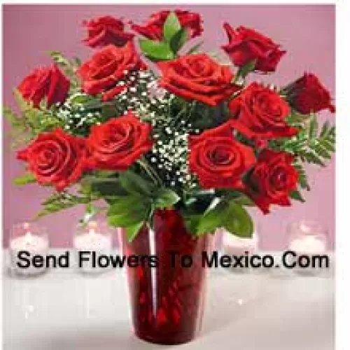 12 Red Roses With Some Ferns In A Glass Vase