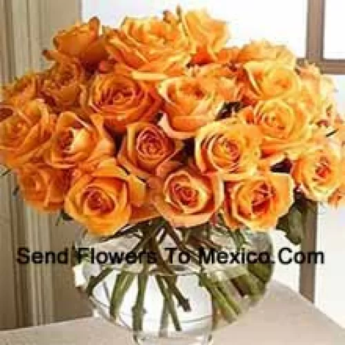 25 Orange Roses With Some Ferns In A Glass Vase